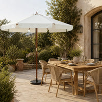 3.3m sand white market umbrella beside a timber outdoor dining table in a garden alfresco setting