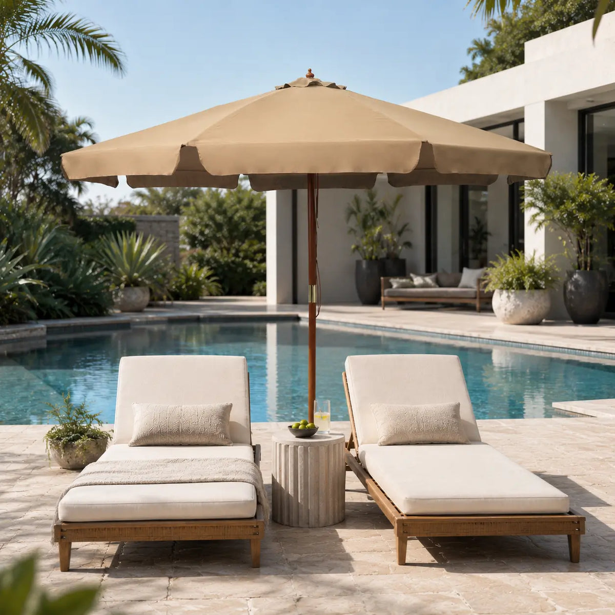 Taupe market umbrella providing shade over timber sun loungers beside an outdoor pool