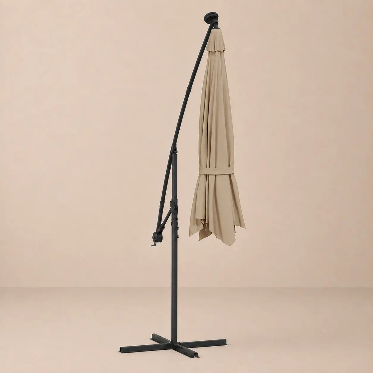 Round cantilever umbrella 3m Taupe folded and secured with carry strap on cross stand with solar panel – Meltem
