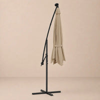 Round cantilever umbrella 3m Taupe folded and secured with carry strap on cross stand with solar panel – Meltem