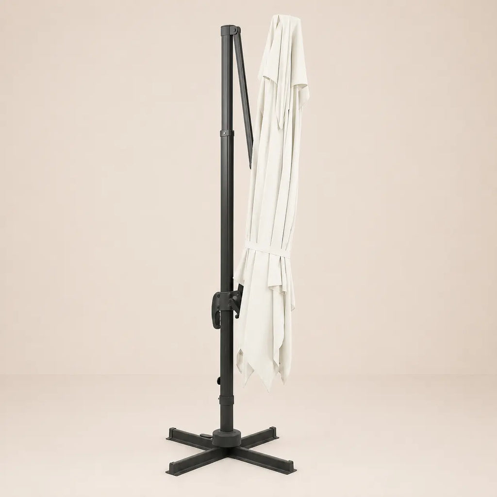 Sirocco ivory cantilever umbrella folded and secured with fabric tie strap for compact storage