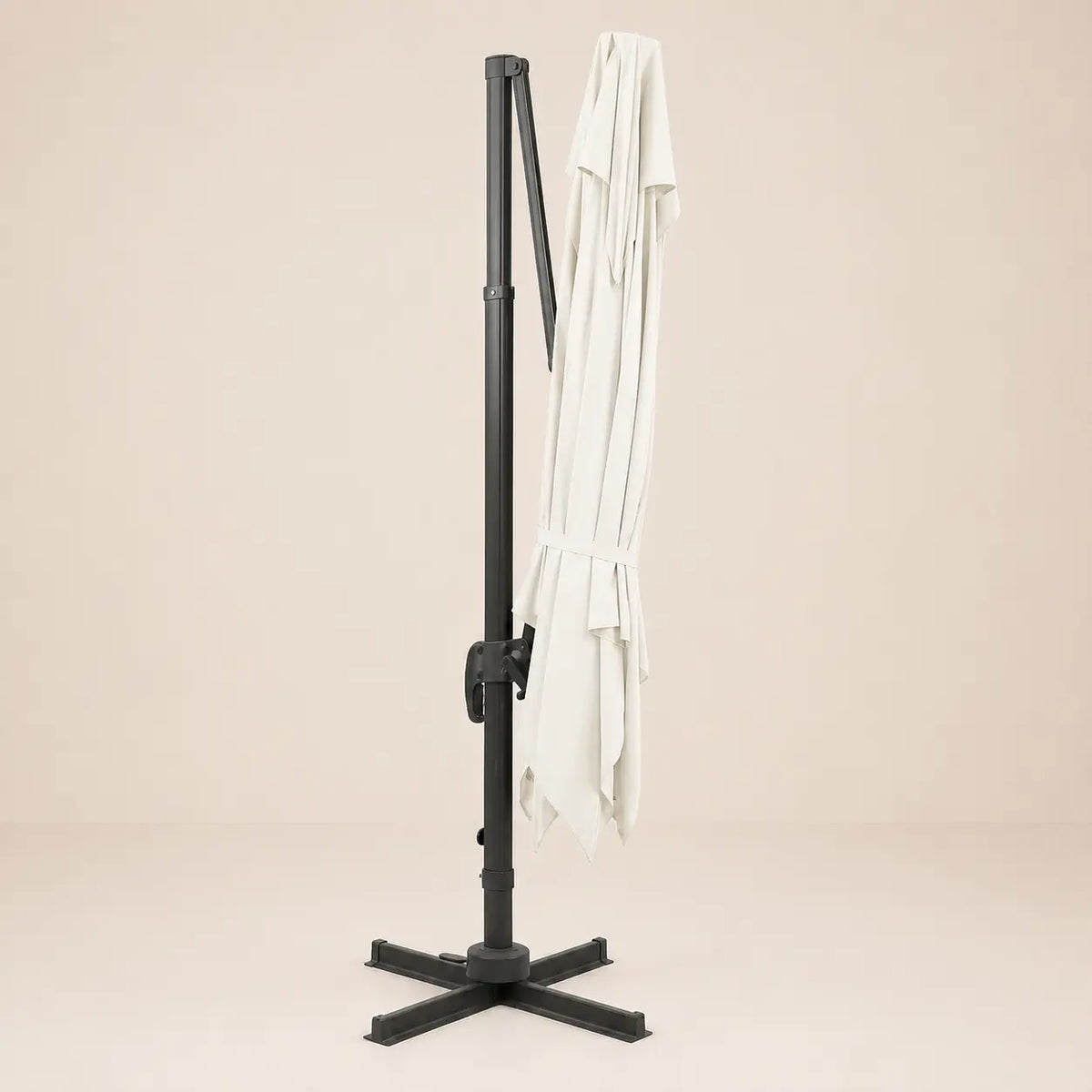 Sirocco ivory cantilever umbrella folded and secured with fabric tie strap for compact storage