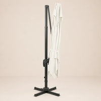 Sirocco ivory cantilever umbrella folded and secured with fabric tie strap for compact storage