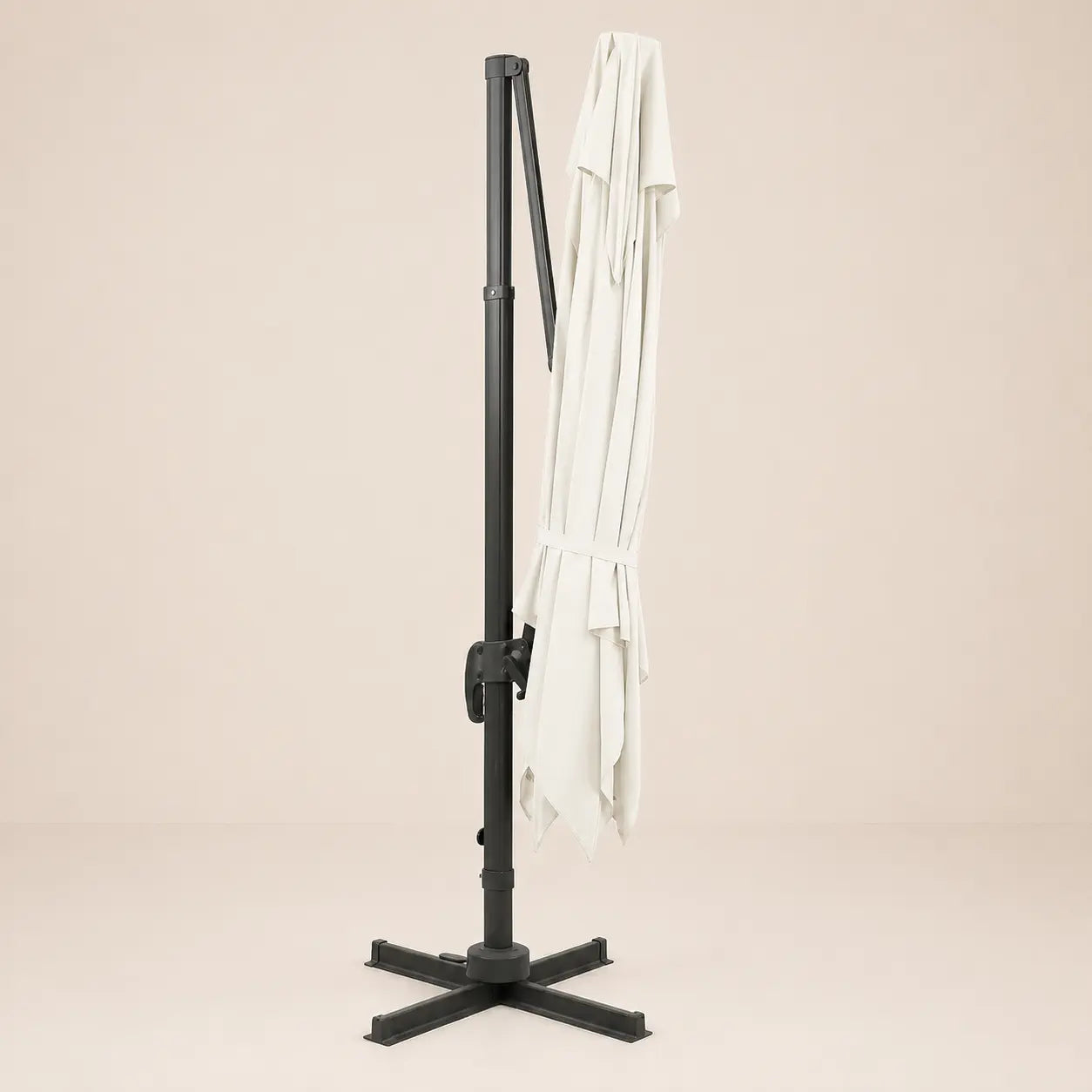 Sirocco ivory cantilever umbrella folded and secured with fabric tie strap for compact storage