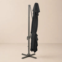Mistral XL black rectangular cantilever umbrella folded and secured with fabric tie strap for compact storage