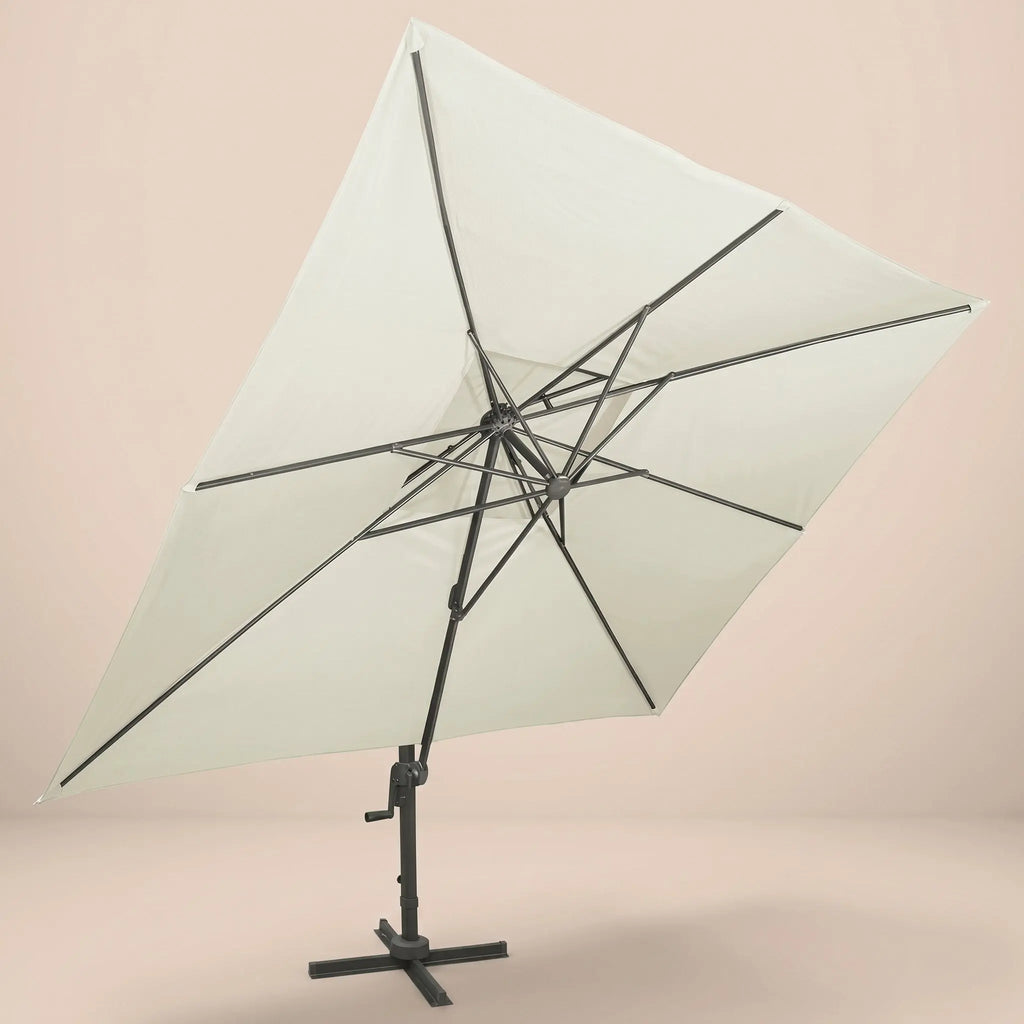 Underside view of the tilted rectangular cantilever umbrella showing the reinforced aluminium rib frame and ivory canopy