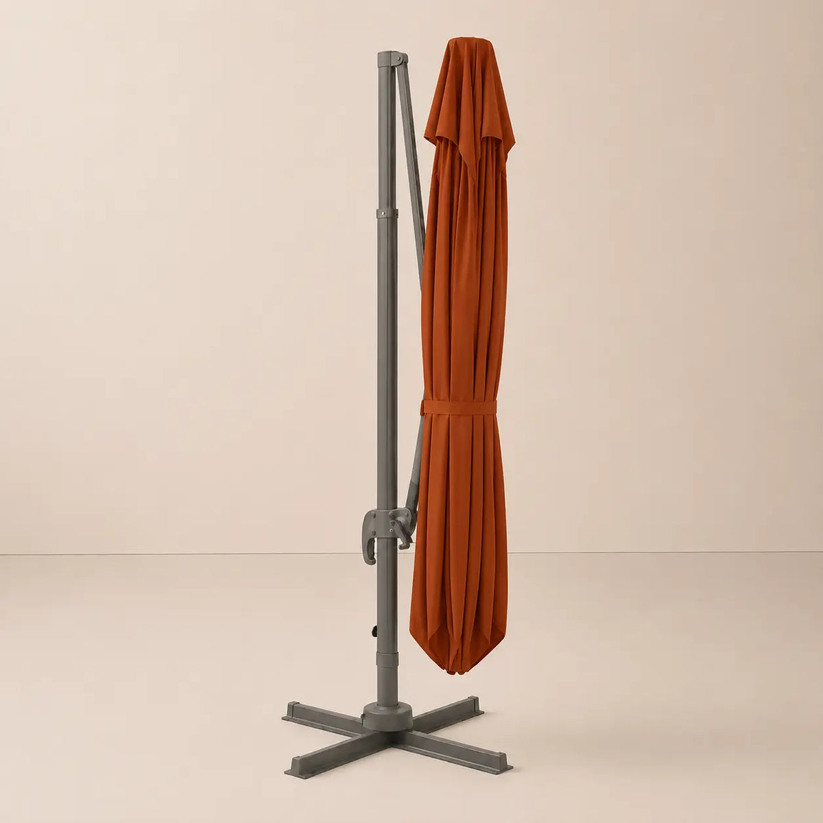 Terracotta cantilever umbrella fully closed with tie strap – compact folded position, dark grey aluminium frame, 3x4m outdoor umbrella