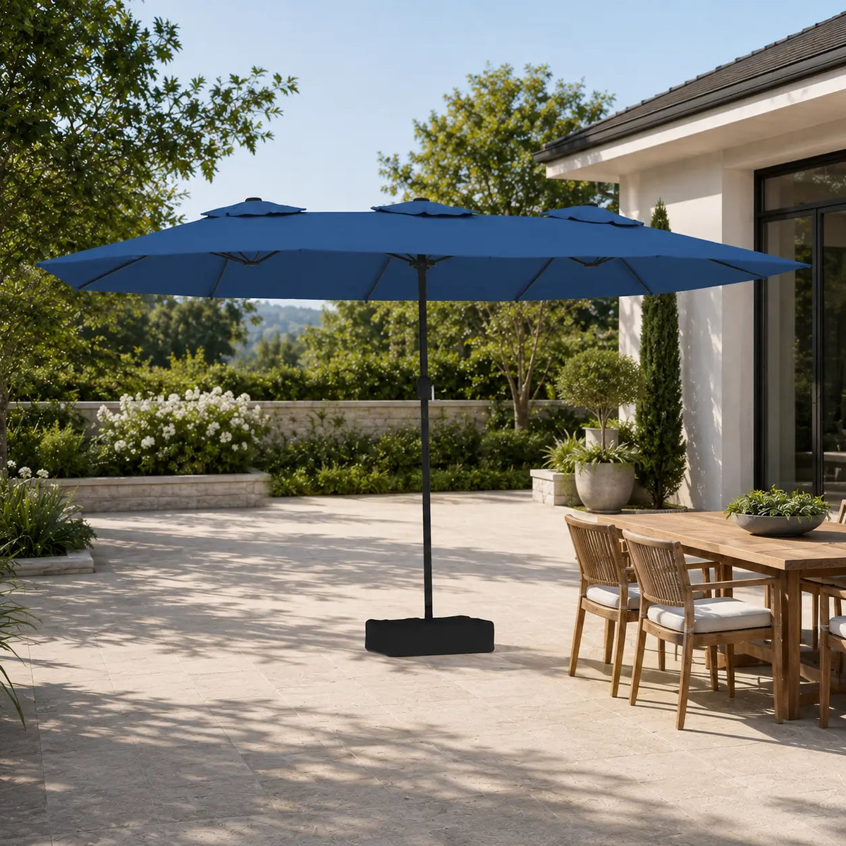 4.5m azure blue double canopy market umbrella shading a timber outdoor dining table in a garden alfresco setting