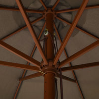 Underside view of a taupe market umbrella showing hardwood rib frame, double pulley rope mechanism and brass fittings