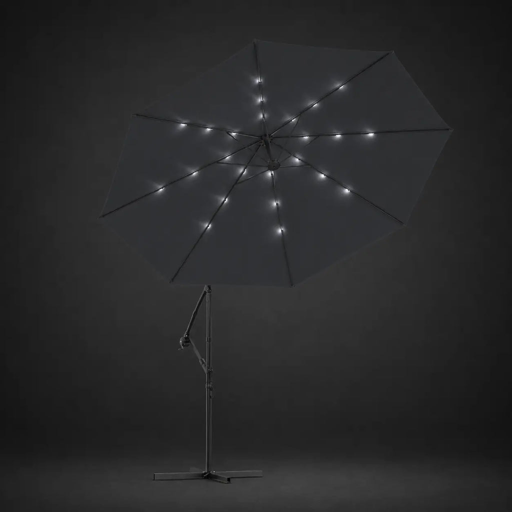Round cantilever umbrella 3m Black with solar LED lights illuminated along ribs at night – Maestro