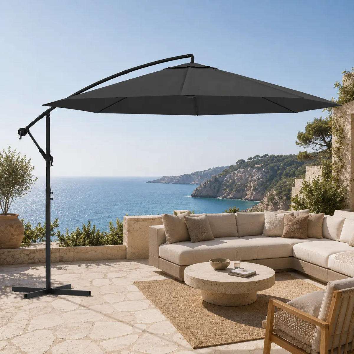 Round cantilever umbrella 3.5m Anthracite shading outdoor sectional sofa on stone coastal terrace – Gregal