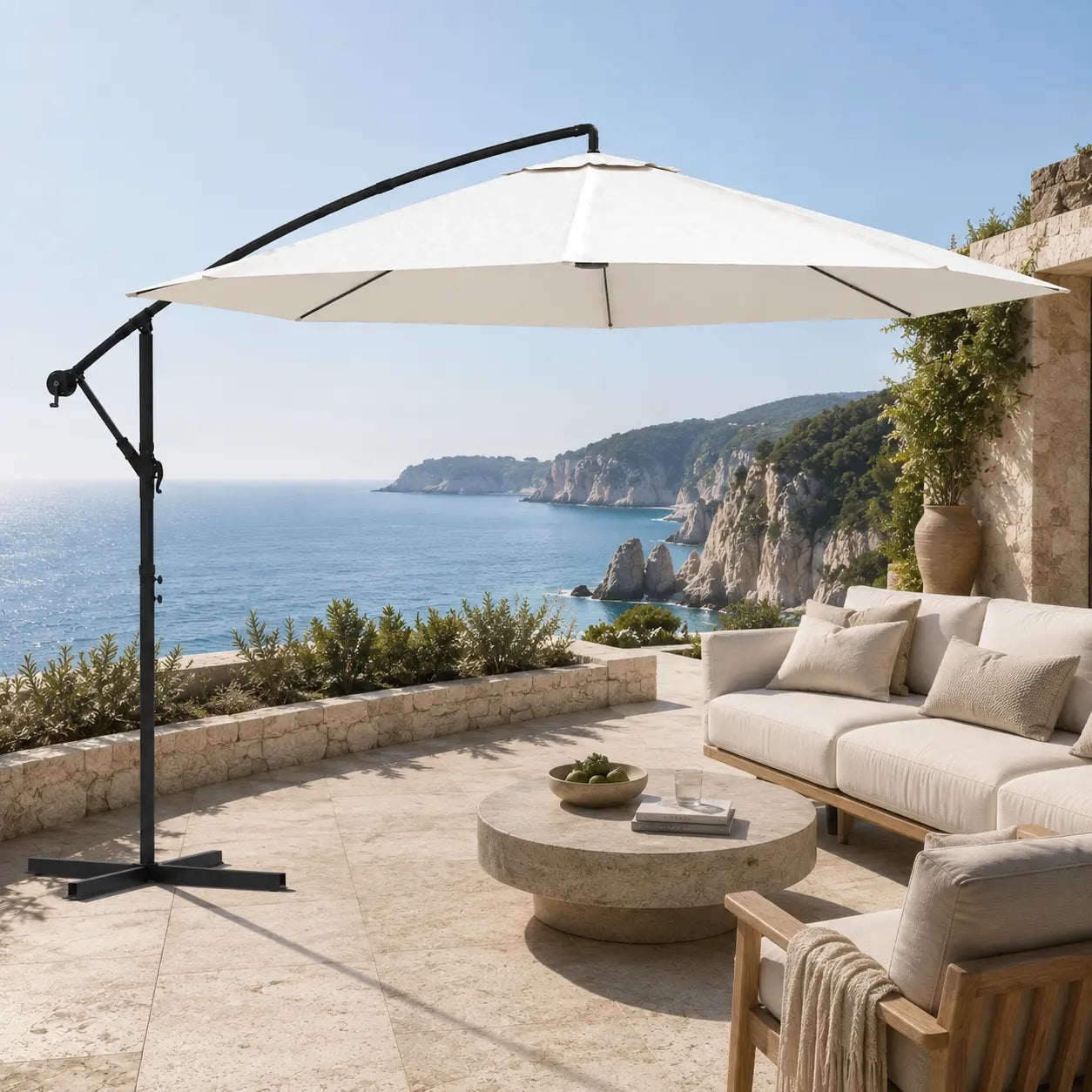 Round cantilever umbrella 3.5m Sand White shading outdoor lounge on stone coastal terrace – Zephyr