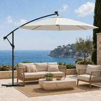 Round cantilever umbrella 3m Sand shading outdoor rope lounge set on stone coastal terrace – Solano