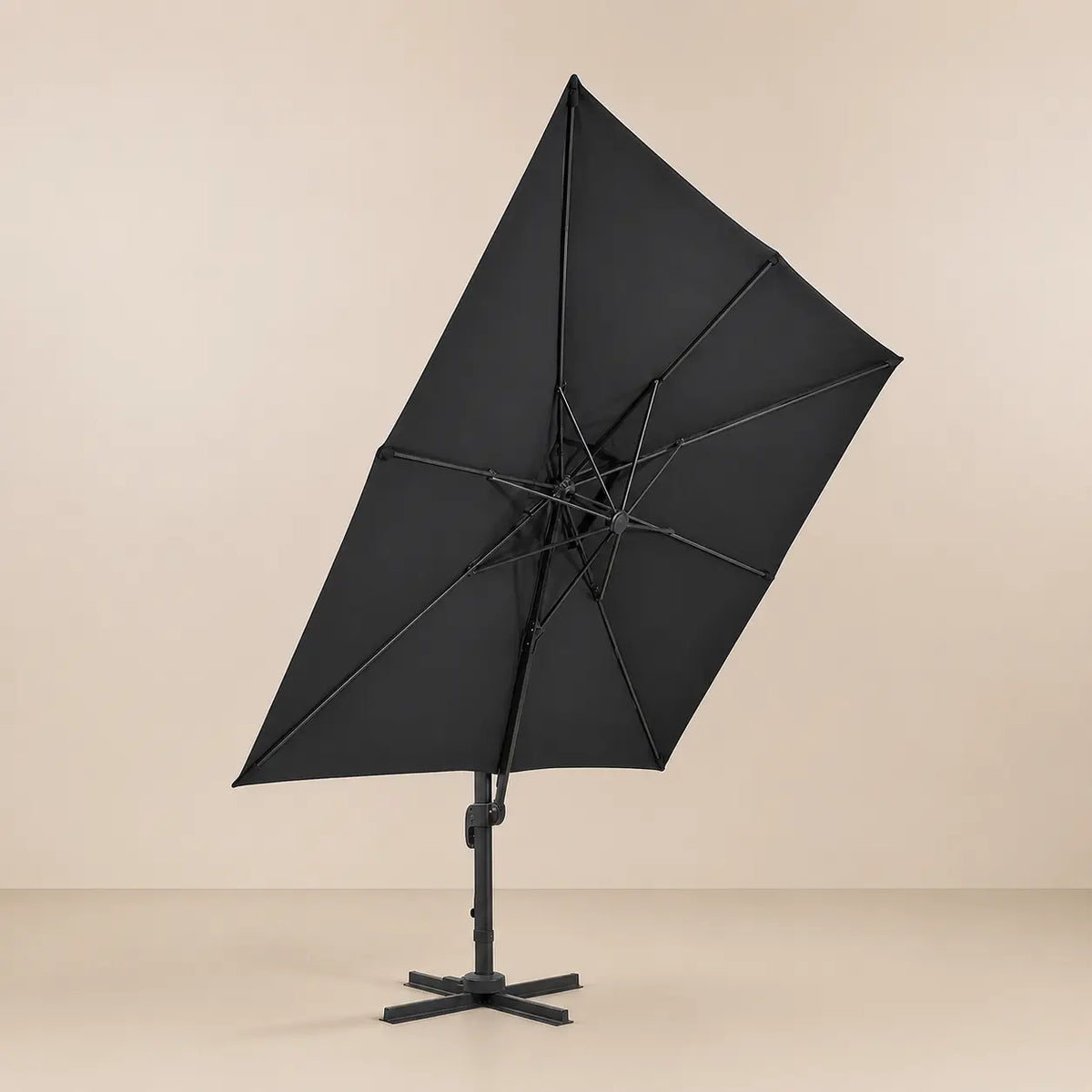 Underside view of the tilted square cantilever umbrella showing the reinforced aluminium rib frame and anthracite canopy