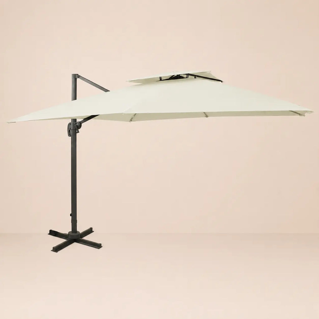 Side profile of the 3x3m ivory cantilever umbrella with double wind-vented canopy and offset aluminium pole