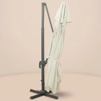 Sirocco XL rectangular cantilever umbrella folded and secured with fabric tie strap for compact storage