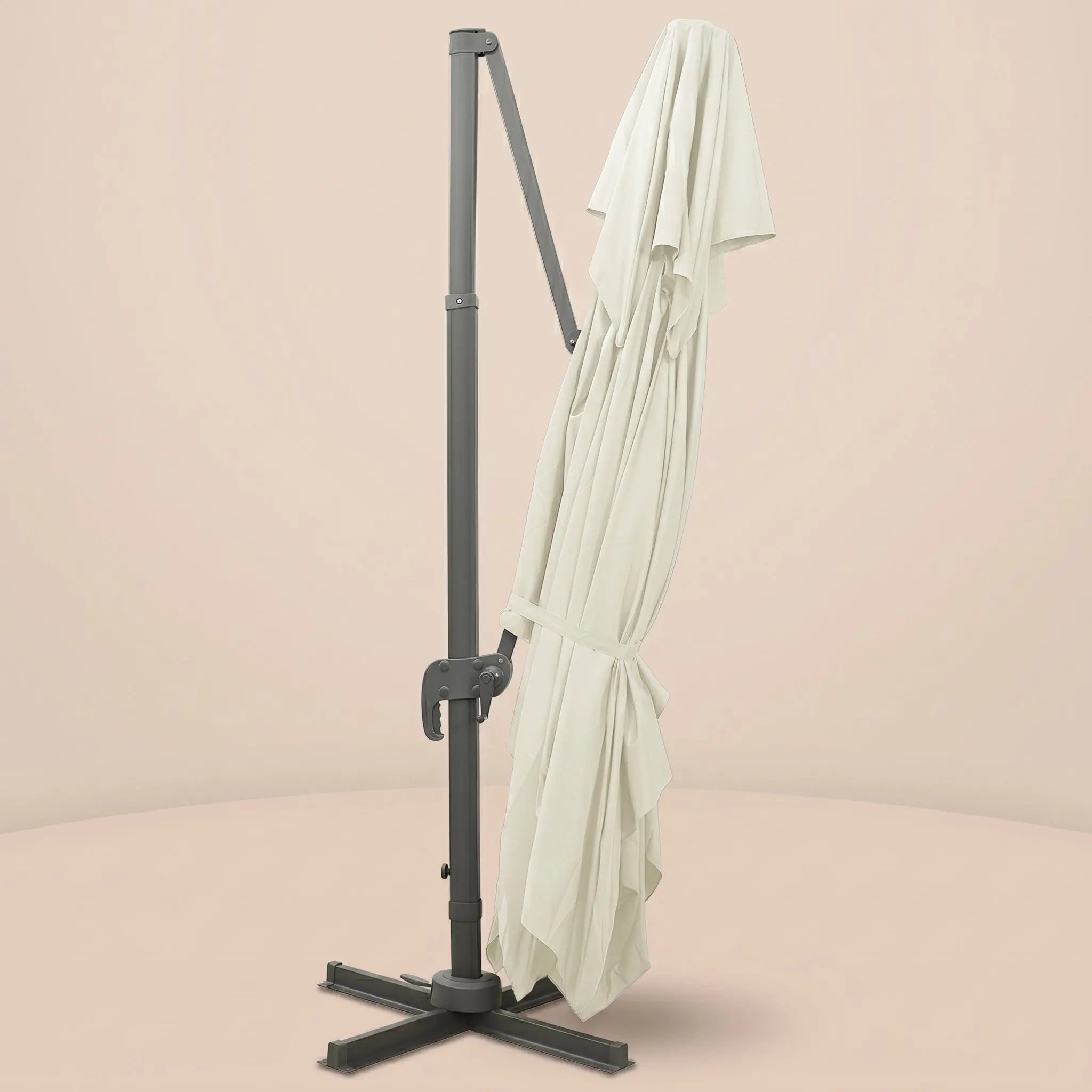 Sirocco XL rectangular cantilever umbrella folded and secured with fabric tie strap for compact storage