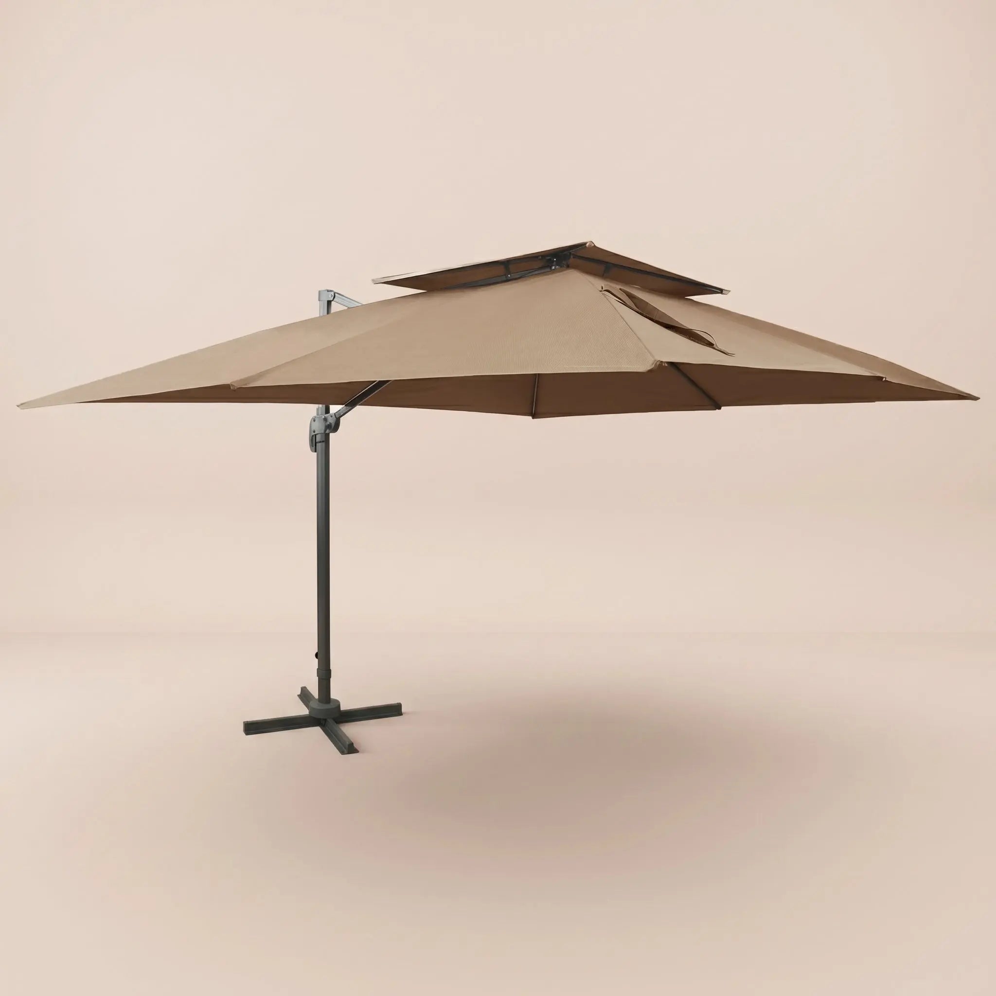 Side profile of the 3x4m taupe cantilever umbrella with double wind-vented canopy and offset aluminium pole