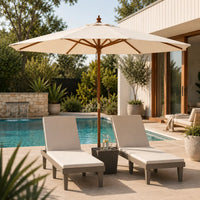 Sand market umbrella with hardwood pole providing shade over two pool loungers beside an Australian backyard pool