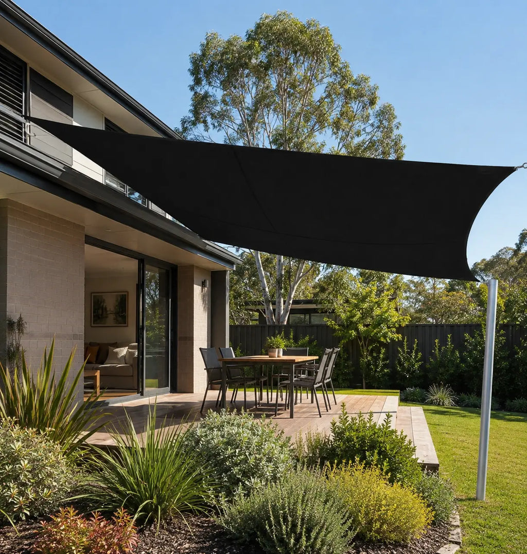 black rectangular shade sail installed over an outdoor lounge area on an Australian modern home patio