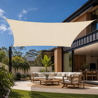 cream rectangular shade sail installed over an outdoor lounge area on an Australian modern home patio