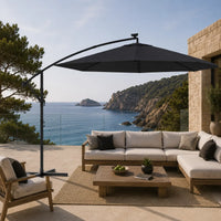 Round cantilever umbrella 3m Black shading outdoor teak sectional sofa on coastal terrace with glass railing – Maestro