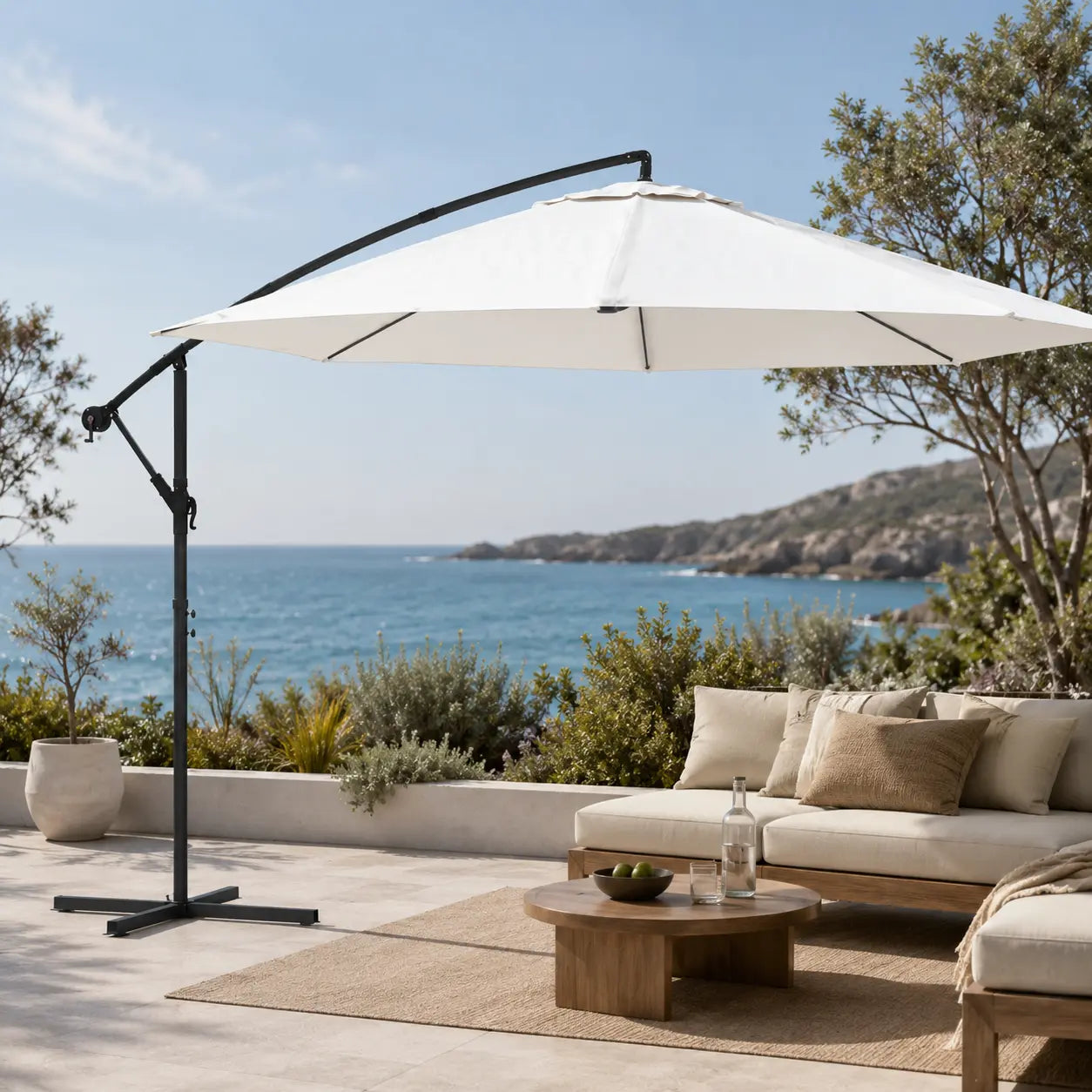 Round cantilever umbrella 3.5m Sand White over outdoor sofa on open sea-view patio with jute rug – Zephyr