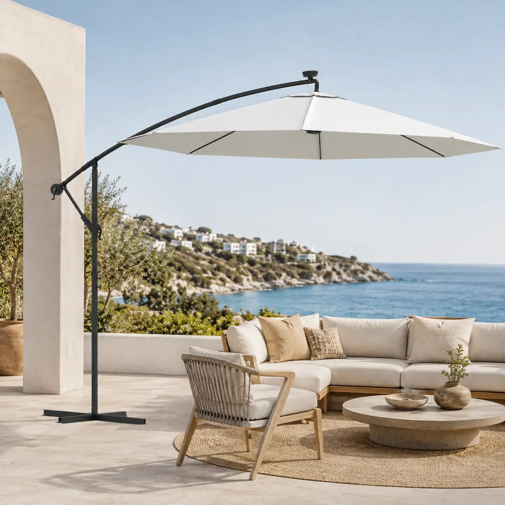 Round cantilever umbrella 3m Sand over outdoor sectional sofa on villa patio with sea view – Solano
