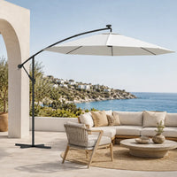Round cantilever umbrella 3m Sand over outdoor sectional sofa on villa patio with sea view – Solano