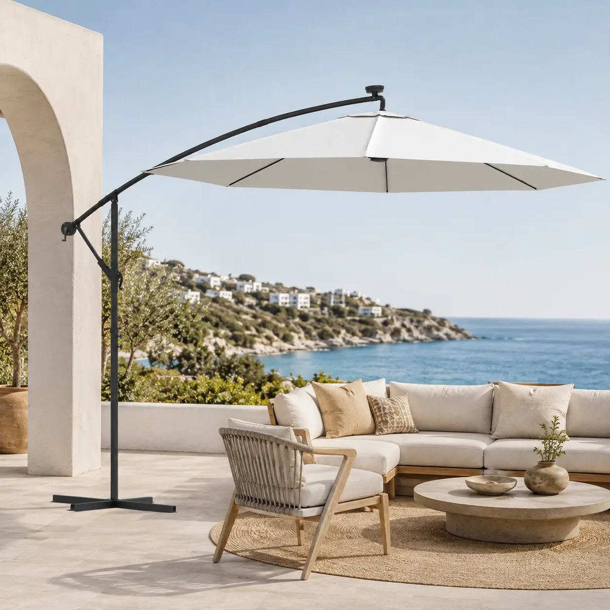 Round cantilever umbrella 3m Sand over outdoor sectional sofa on villa patio with sea view – Solano