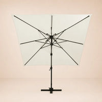Rear view of the Sirocco square cantilever umbrella with eight-rib frame and vented double canopy in ivory