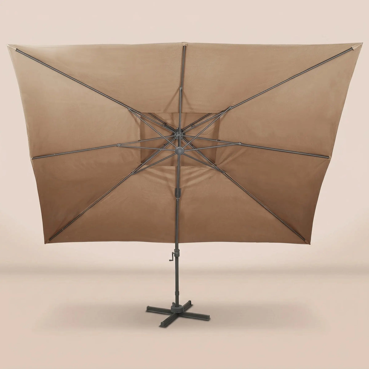 Rear view of the Tramontane XL 3x4m cantilever umbrella with eight-rib frame and vented double canopy in taupe