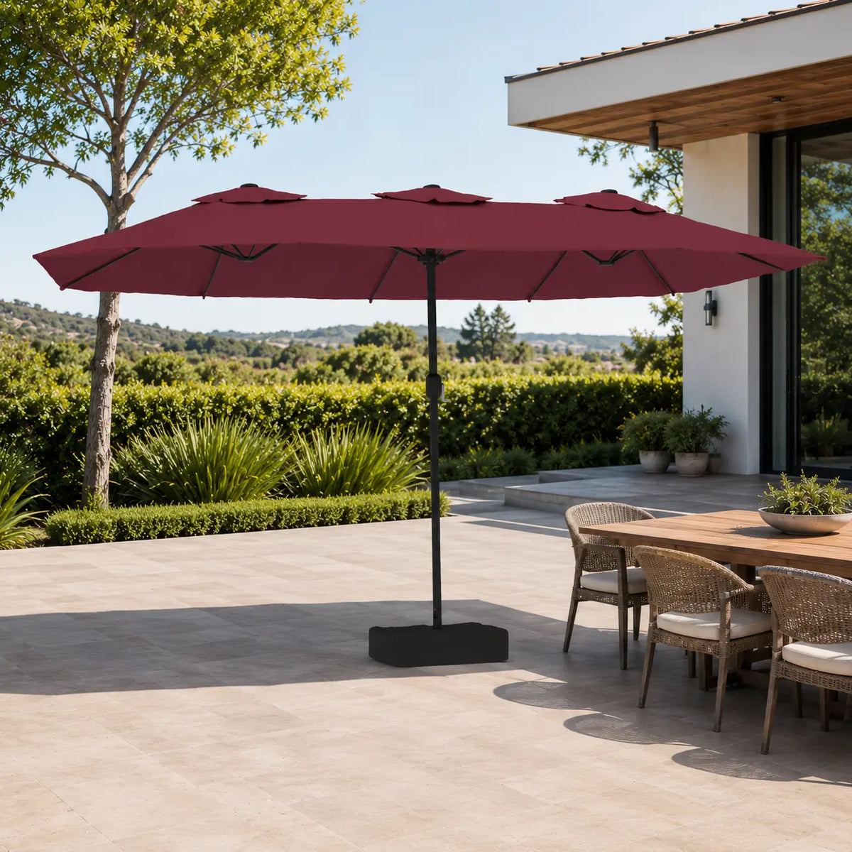 4.5m bordeaux double canopy market umbrella shading a wicker outdoor dining table in a garden alfresco setting